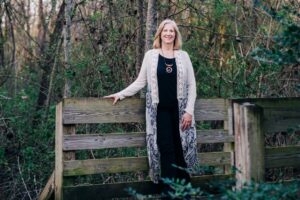 Sara Dochterman - standing with hand resting on fence